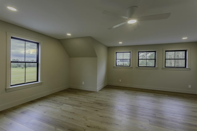 bonus room with ceiling fan, lofted ceiling, and light wood-type flooring