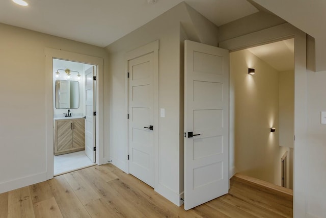 hallway with light hardwood / wood-style floors