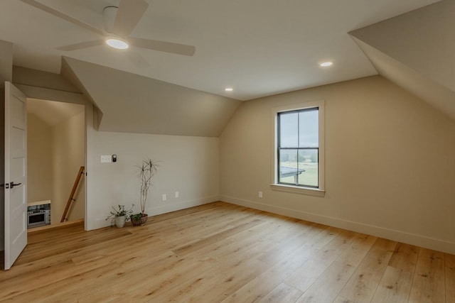 additional living space with ceiling fan, light hardwood / wood-style flooring, and vaulted ceiling