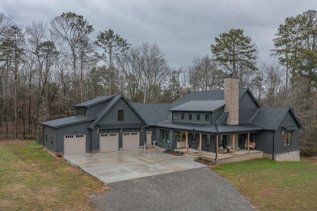 craftsman inspired home featuring covered porch, a garage, and a front lawn