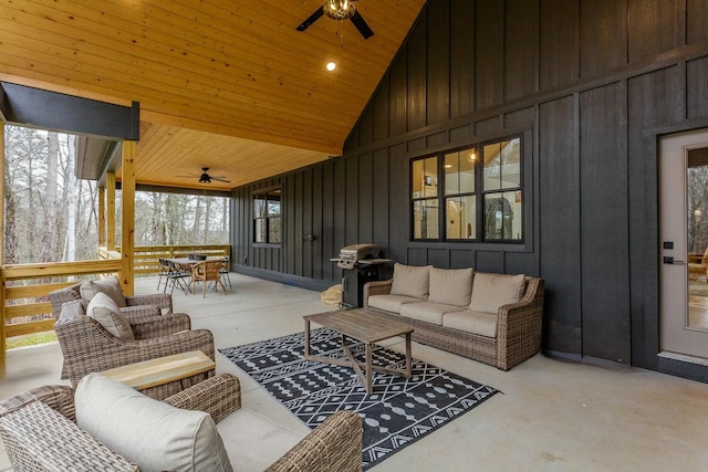 snow covered patio with an outdoor living space and ceiling fan