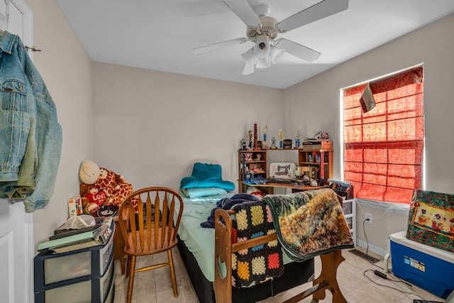 bedroom featuring multiple windows and ceiling fan