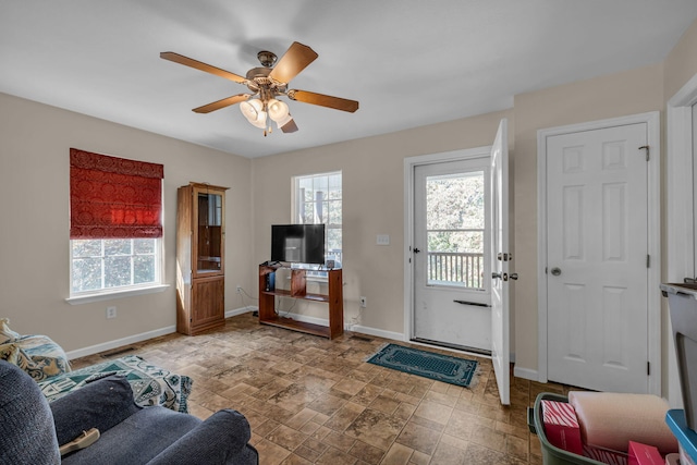 interior space with ceiling fan