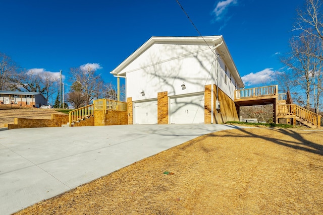 view of side of property featuring a deck and a garage