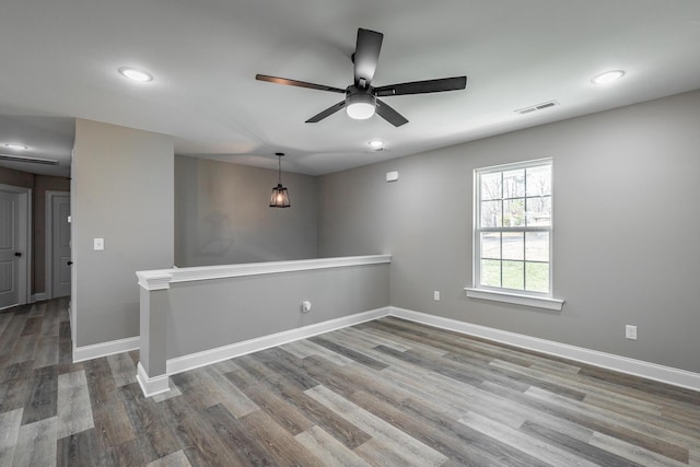 empty room featuring ceiling fan and hardwood / wood-style floors