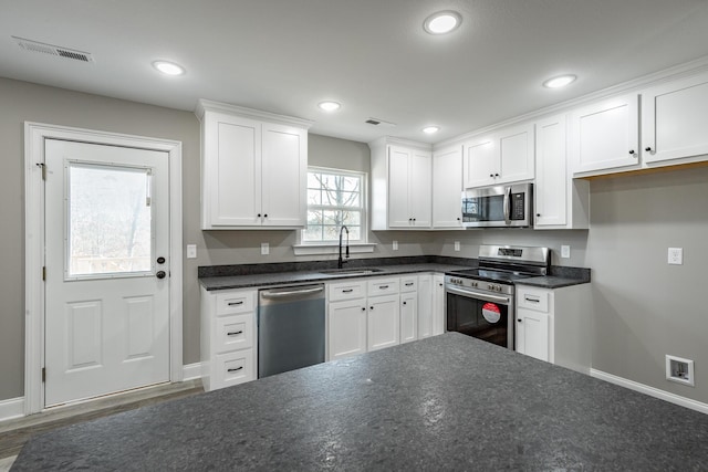 kitchen featuring stainless steel appliances, dark hardwood / wood-style floors, white cabinets, and sink