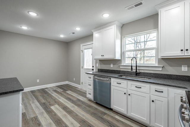 kitchen featuring sink, white cabinetry, a wealth of natural light, and appliances with stainless steel finishes