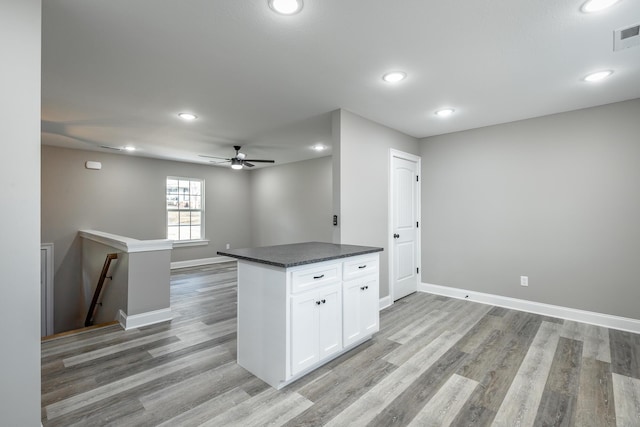 kitchen featuring white cabinetry, ceiling fan, and light hardwood / wood-style floors