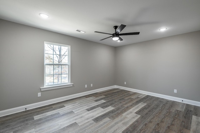 unfurnished room featuring dark hardwood / wood-style flooring and ceiling fan