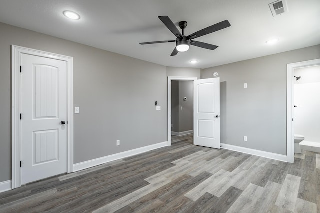 unfurnished bedroom with ceiling fan, light wood-type flooring, and ensuite bath