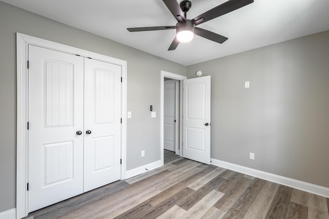 unfurnished bedroom with a closet, ceiling fan, and light hardwood / wood-style floors