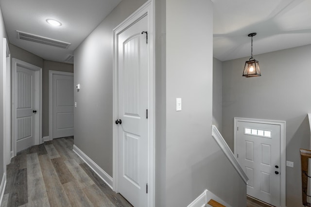 corridor with light hardwood / wood-style floors