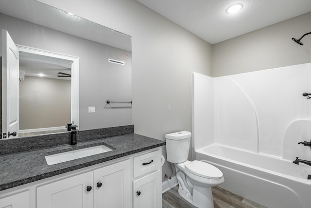 full bathroom featuring hardwood / wood-style floors, bathtub / shower combination, toilet, vanity, and ceiling fan