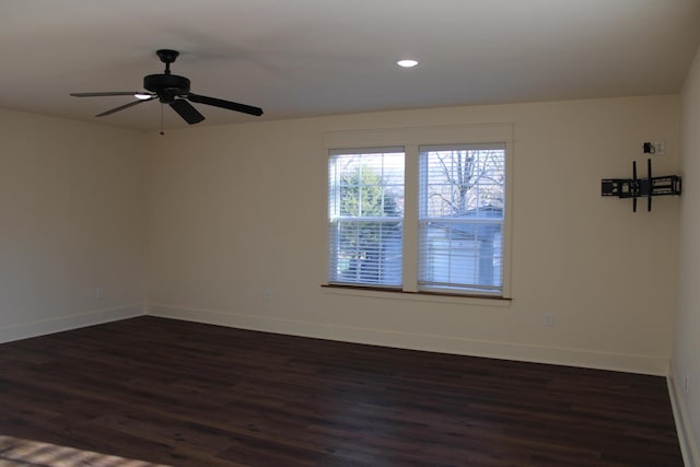 spare room with ceiling fan and dark wood-type flooring