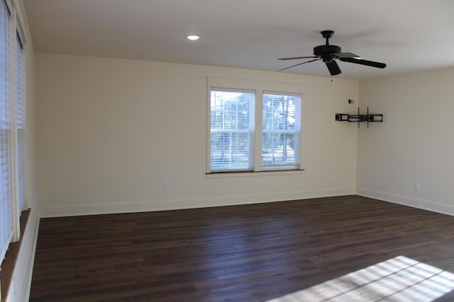 empty room featuring dark hardwood / wood-style flooring and ceiling fan