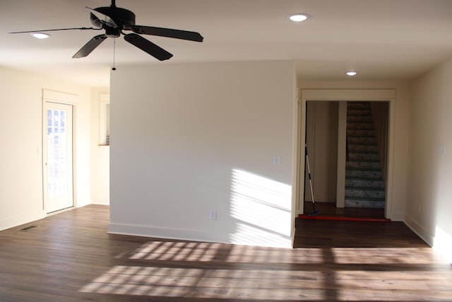 empty room featuring ceiling fan and dark wood-type flooring