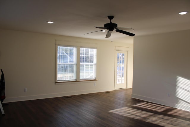 unfurnished living room featuring ceiling fan and dark hardwood / wood-style floors