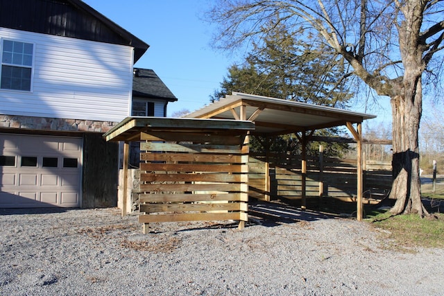 view of home's exterior featuring a carport and a garage