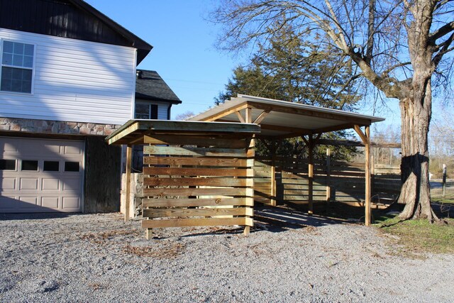 view of home's exterior featuring a carport and a garage