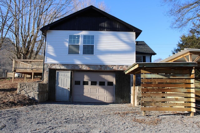 view of front of home featuring a garage and a wooden deck