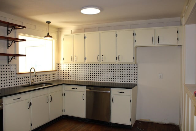 kitchen with dishwasher, sink, white cabinets, and hanging light fixtures