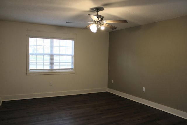 unfurnished room with dark hardwood / wood-style flooring and ceiling fan