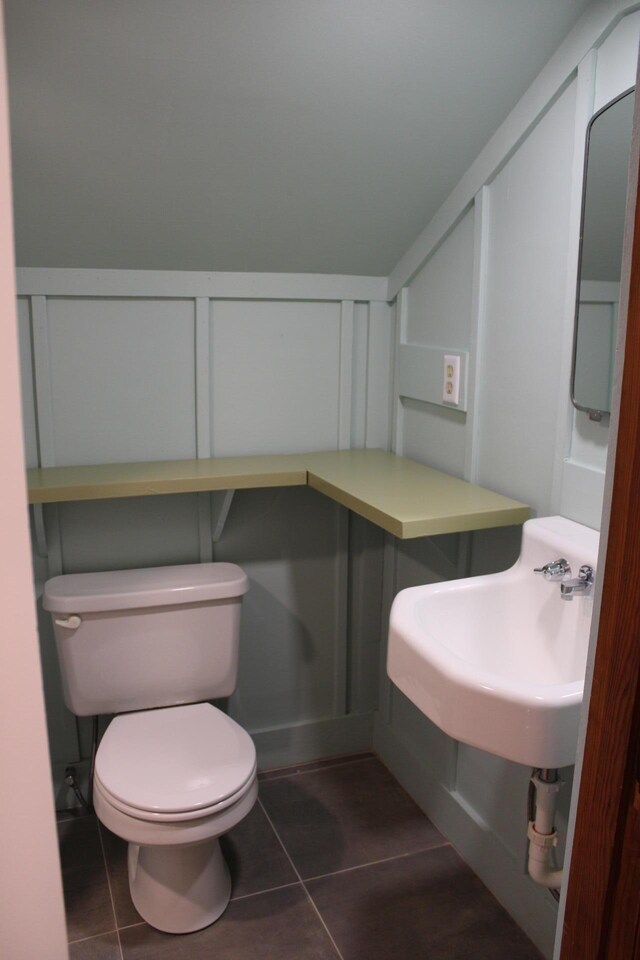 bathroom featuring toilet, tile patterned flooring, and sink