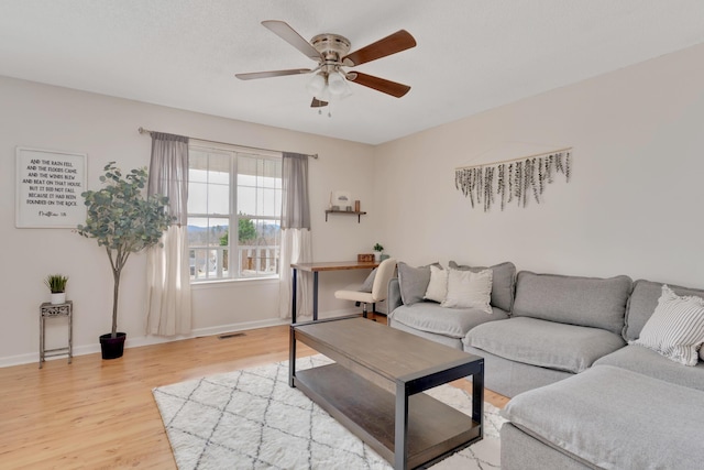 living room featuring hardwood / wood-style flooring and ceiling fan