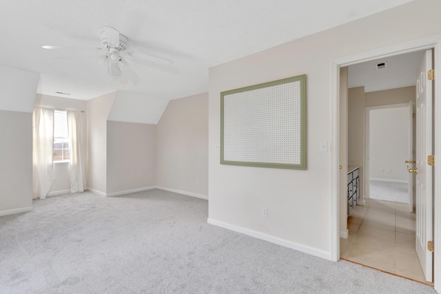 additional living space with ceiling fan, light carpet, and lofted ceiling