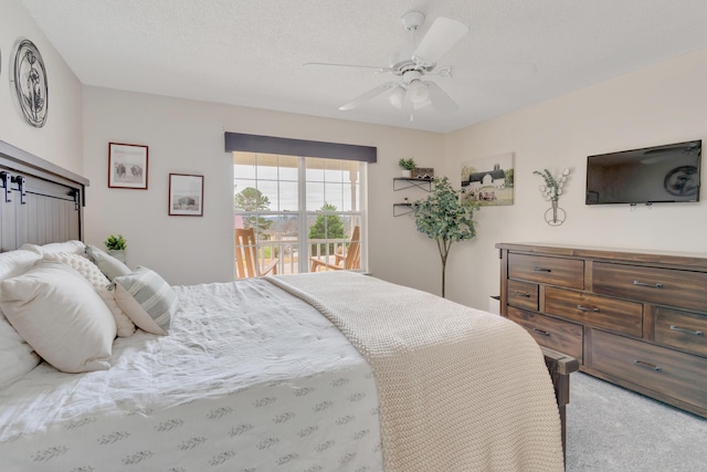 bedroom with light carpet, ceiling fan, and a textured ceiling