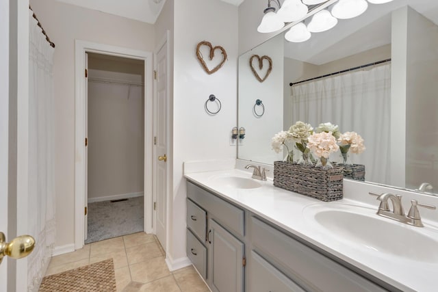 bathroom with tile patterned flooring, vanity, and curtained shower