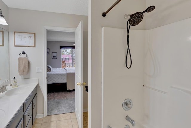 bathroom featuring vanity, tub / shower combination, tile patterned floors, and a textured ceiling