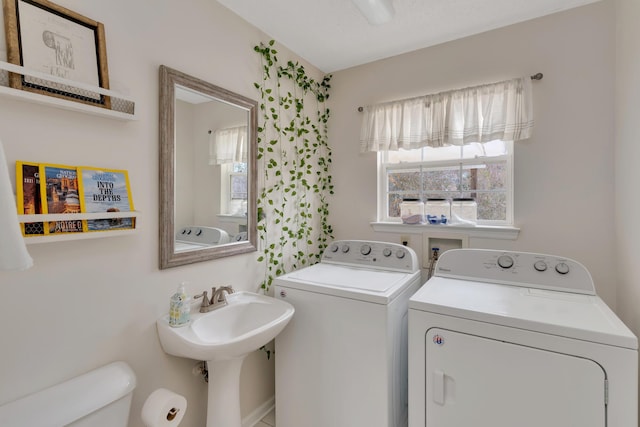 washroom with independent washer and dryer