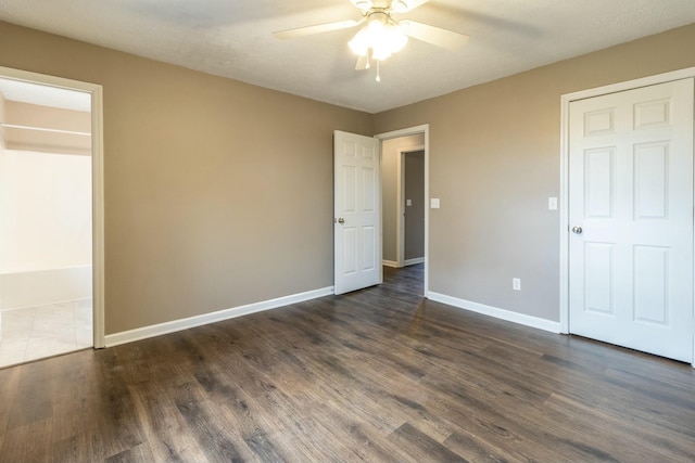 unfurnished bedroom featuring a textured ceiling, ceiling fan, and dark hardwood / wood-style floors