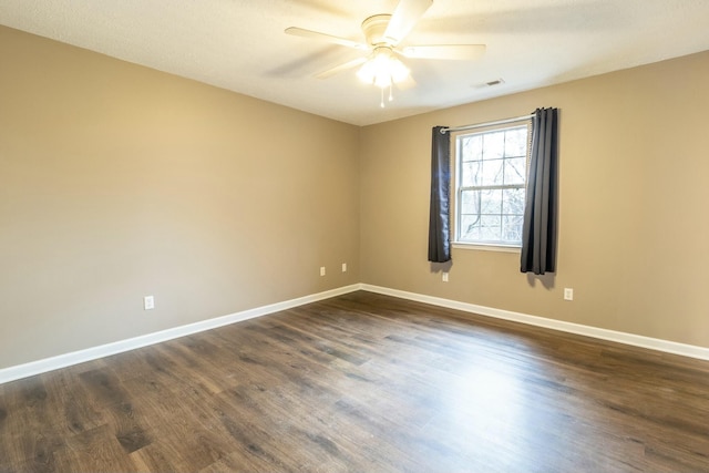 empty room featuring dark hardwood / wood-style floors and ceiling fan