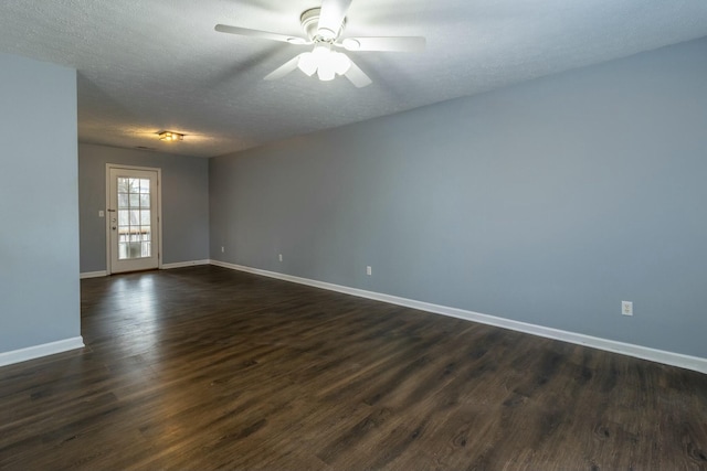 empty room with dark hardwood / wood-style floors, ceiling fan, and a textured ceiling