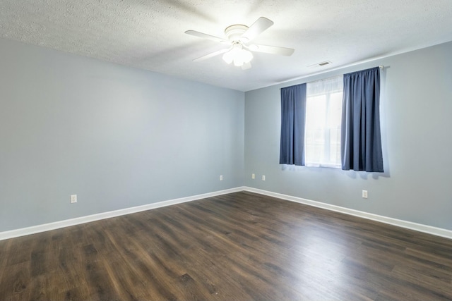 unfurnished room with ceiling fan, dark hardwood / wood-style flooring, and a textured ceiling