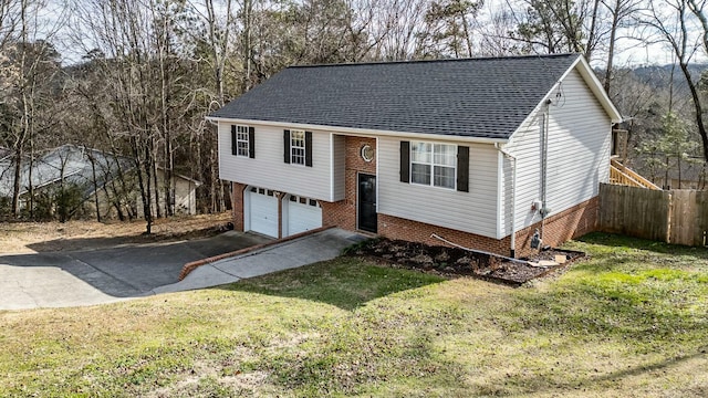 bi-level home with a garage and a front lawn