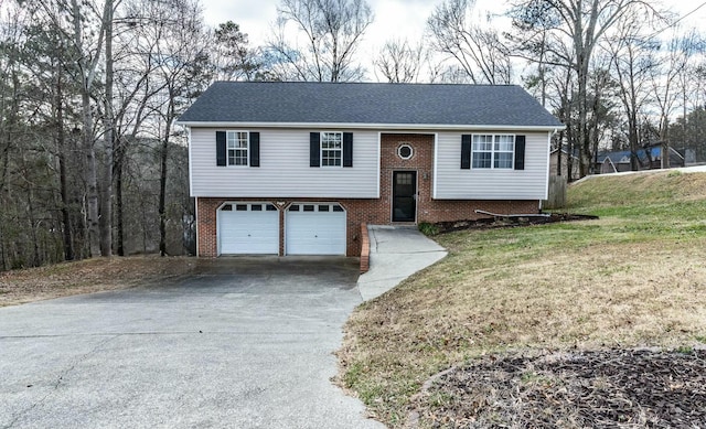 bi-level home featuring a front yard and a garage