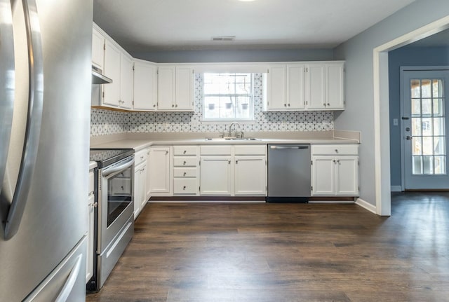 kitchen with white cabinets, dark hardwood / wood-style flooring, stainless steel appliances, and sink