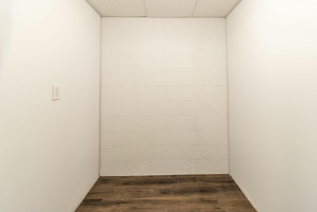 empty room featuring dark hardwood / wood-style flooring and a paneled ceiling