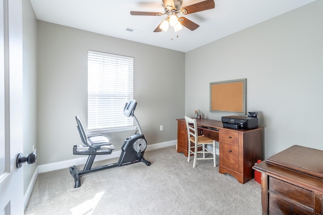 carpeted office featuring ceiling fan