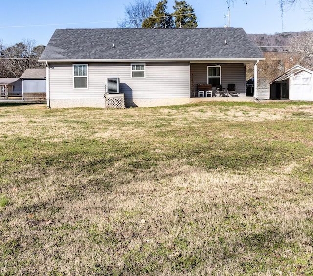 back of property with a yard and a patio