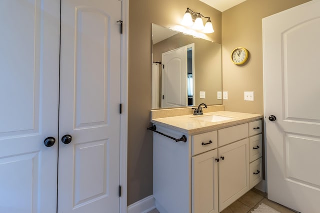 bathroom with tile patterned floors and vanity