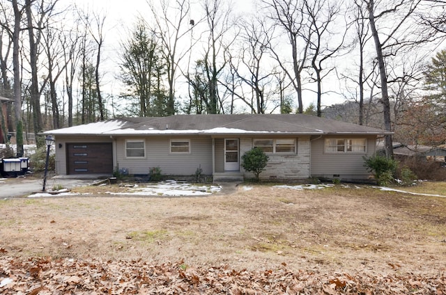 ranch-style house with a garage and a front lawn