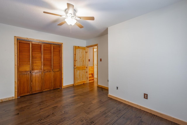 unfurnished bedroom with ceiling fan, a closet, and dark hardwood / wood-style floors