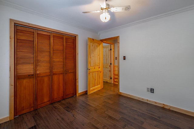 unfurnished bedroom featuring ceiling fan, dark wood-type flooring, a closet, and ornamental molding