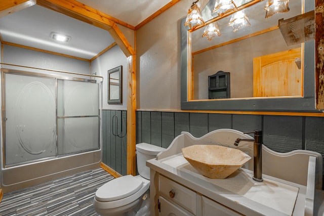 full bathroom with shower / bath combination with glass door, vanity, and toilet