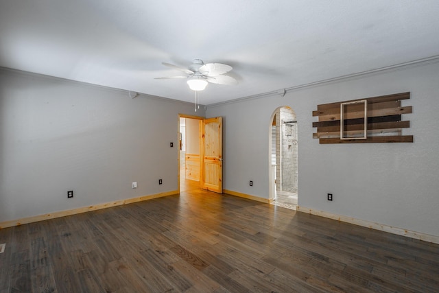 unfurnished room featuring ceiling fan, dark hardwood / wood-style flooring, and ornamental molding