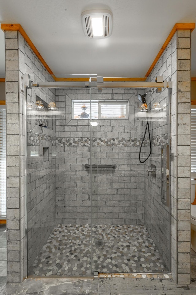 bathroom featuring toilet and a shower with shower door